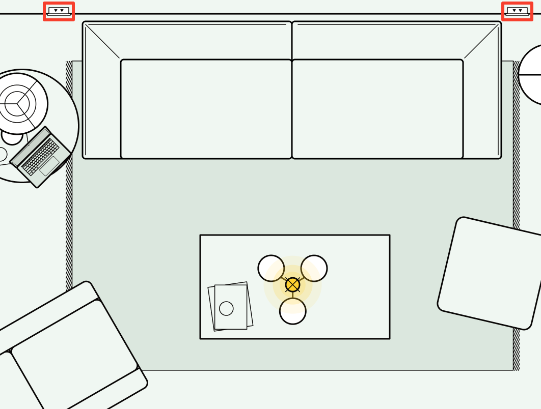 An illustration of a living room floor plan showing useful plug socket positions either side of the sofa