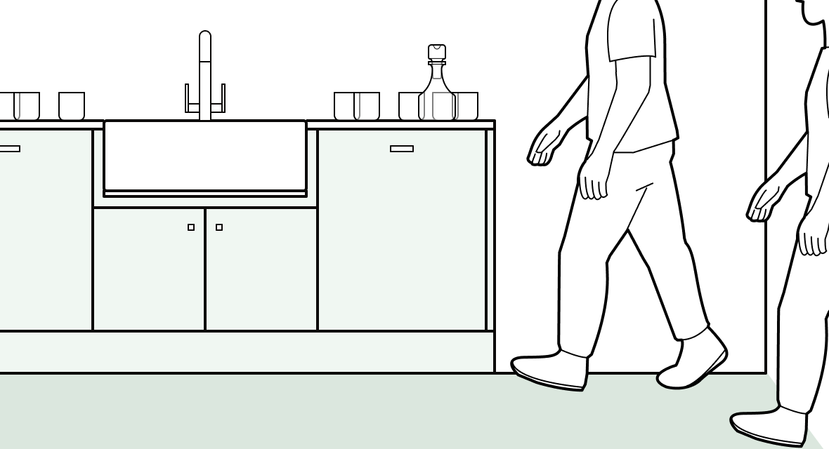 People moving through a kitchen while renovation work is ongoing